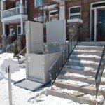 Savaria Multilift vertical platform lift shown in winter with access ramp and call station mounted. Acrylic fascia panel. Savaria Multilift vertical platform lift shown in winter with access ramp and call station mounted. Acrylic fascia panel.
